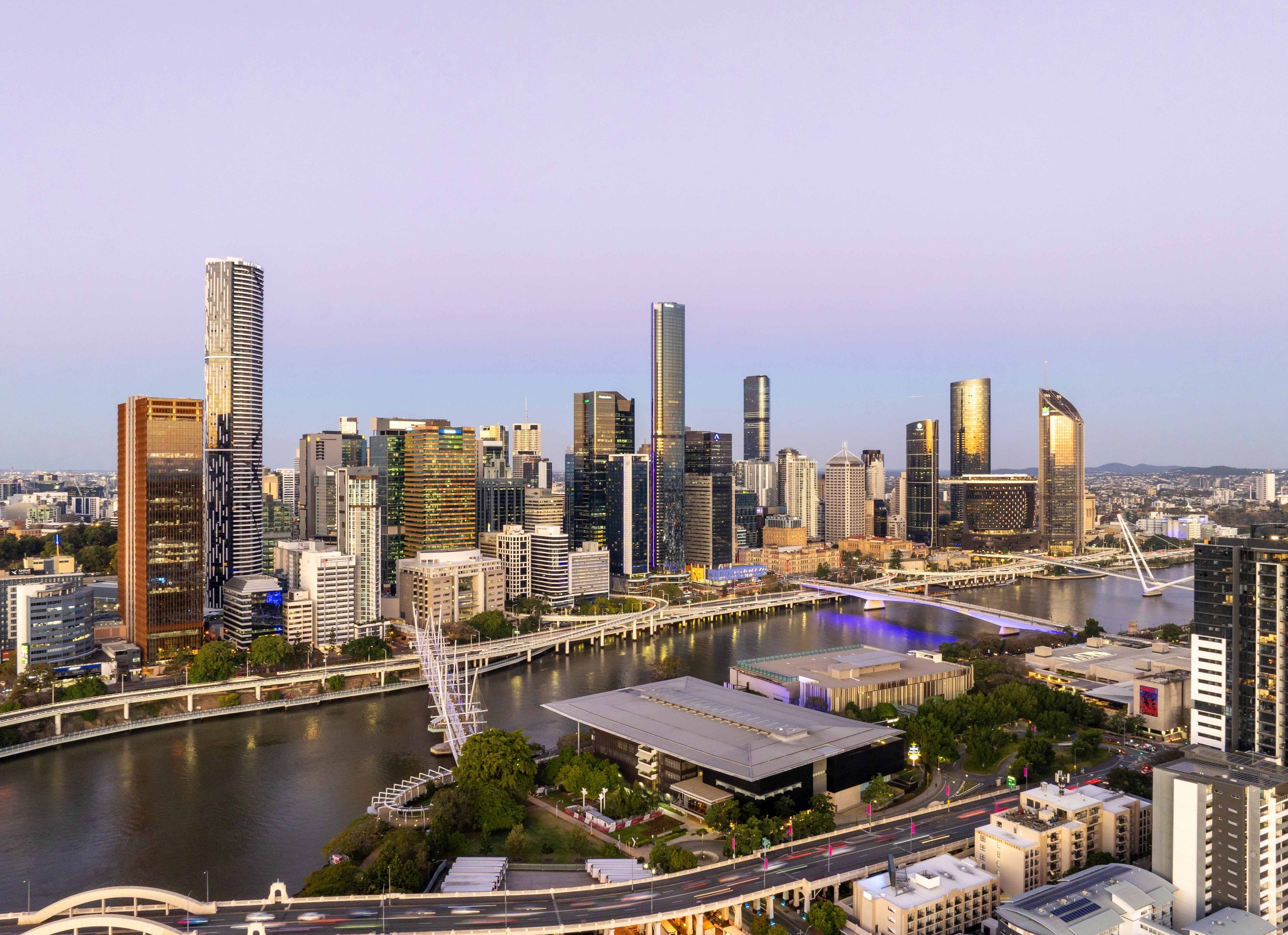 Brisbane Construction Projects Transforming the Skyline at Dusk Brisbane city skyline at dusk showing prominent high-rise construction projects and evolving architecture.